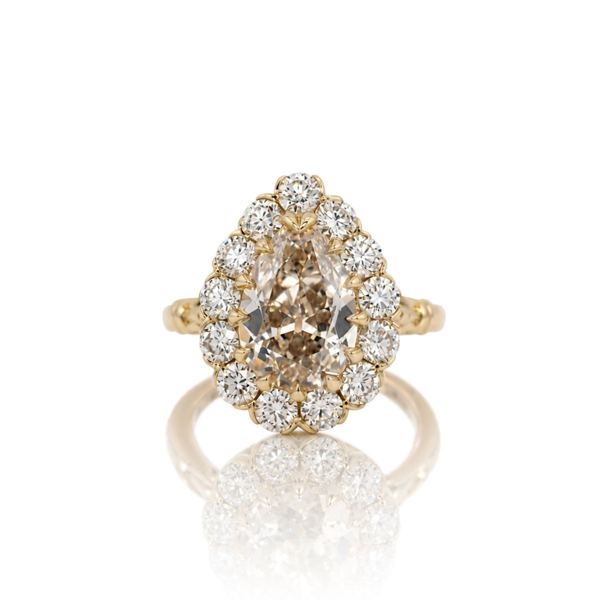 3.01ct antique cut pear lab diamond halo ring in 14k yellow gold, shown head on against a white background