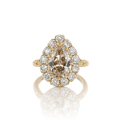 3.01ct antique cut pear lab diamond halo ring in 14k yellow gold, shown head on against a white background