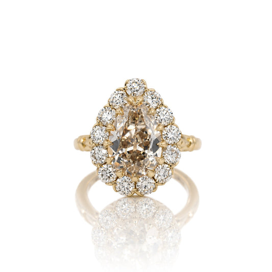 3.01ct antique cut pear lab diamond halo ring in 14k yellow gold, shown head on against a white background