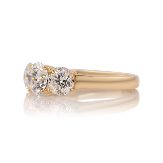 Side profile of the three stone ring showing the half bezel settings