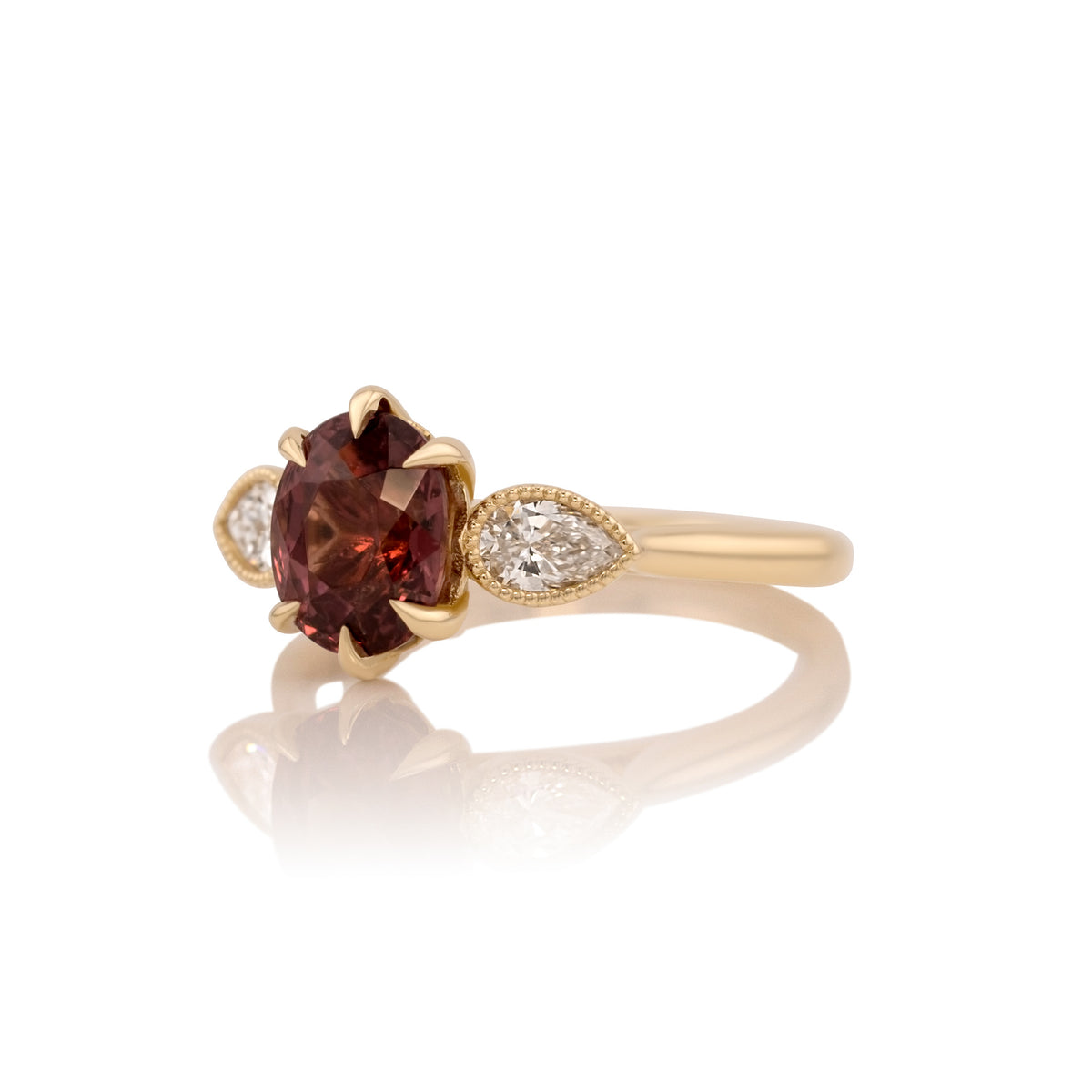 Side profile of the Malaya garnet ring showing the setting and band