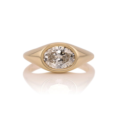 1.59ct oval lab diamond east west ring in 14k yellow gold, shown head on against a white background
