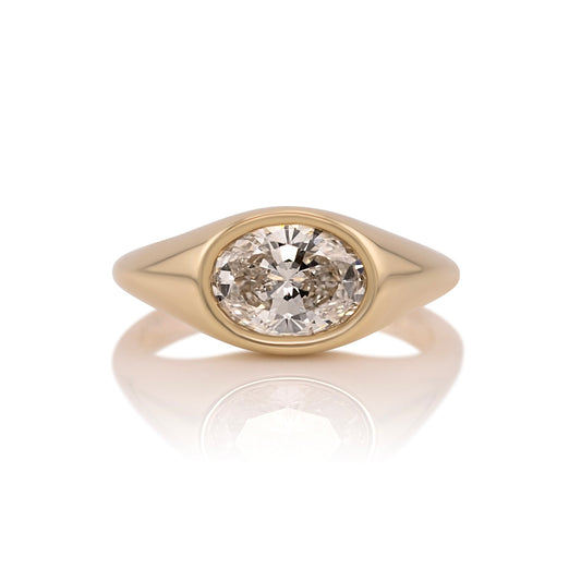 1.59ct oval lab diamond east west ring in 14k yellow gold, shown head on against a white background
