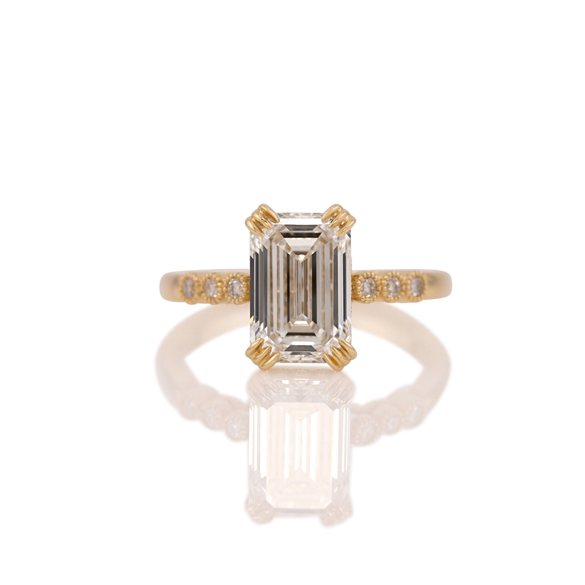 3.06ct emerald cut lab diamond ring in 14k yellow gold, shown head on against a white background