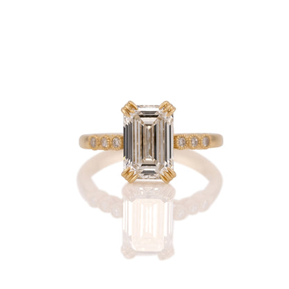 3.06ct emerald cut lab diamond ring in 14k yellow gold, shown head on against a white background
