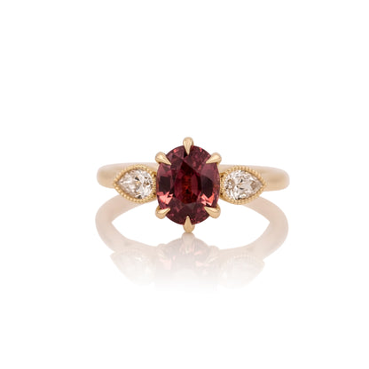 2.44ct oval Malaya garnet ring in 14k yellow gold, shown head on against a white background