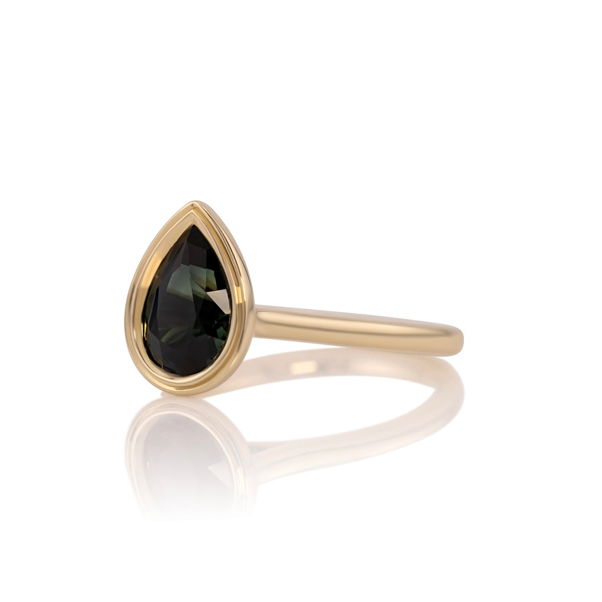Side profile of the sapphire pear ring showing the double bezel setting