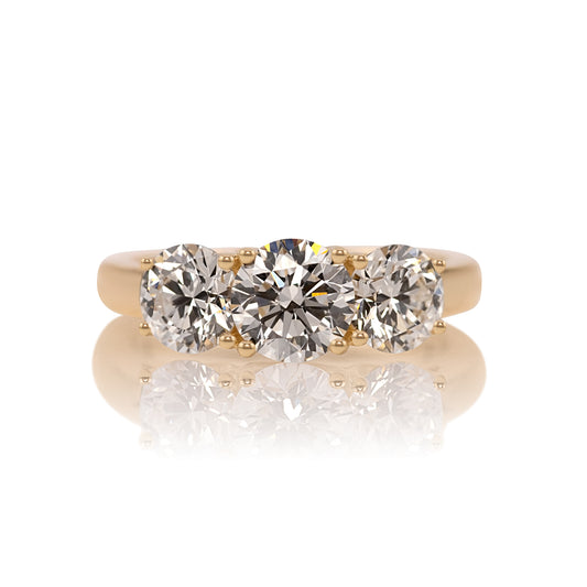 2.50ctw round lab diamond three stone ring in 14k yellow gold, shown head on against a white background