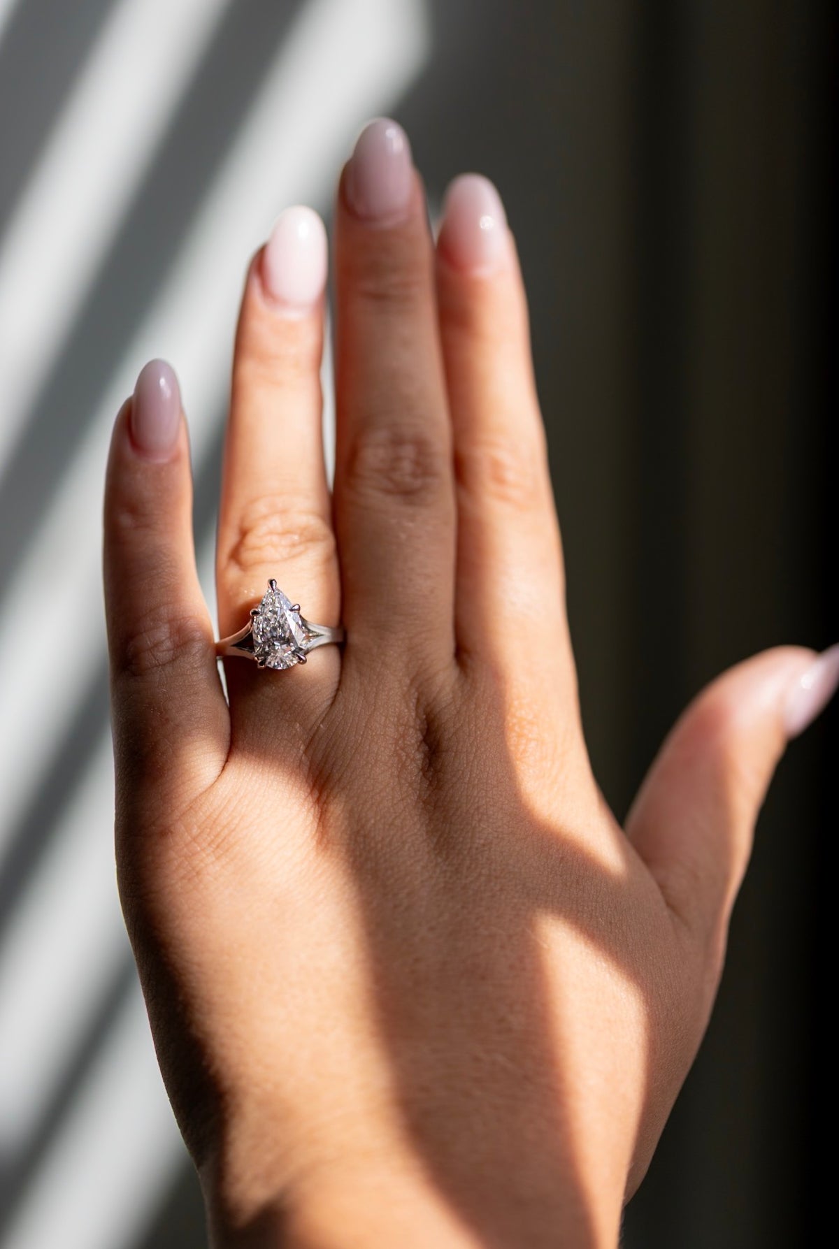 2.42ct pear split shank ring worn on the hand in platinum