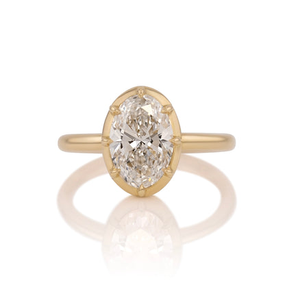 2.04ct oval lab diamond collet ring in 14k yellow gold, shown head on against a white background