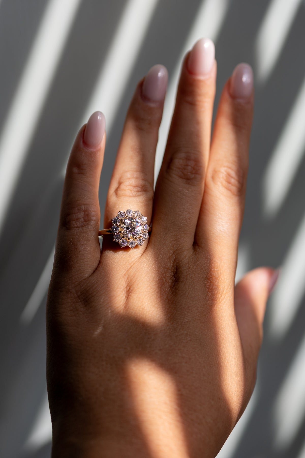 2.64ct old mine cut halo ring worn on the hand in 14k yellow gold