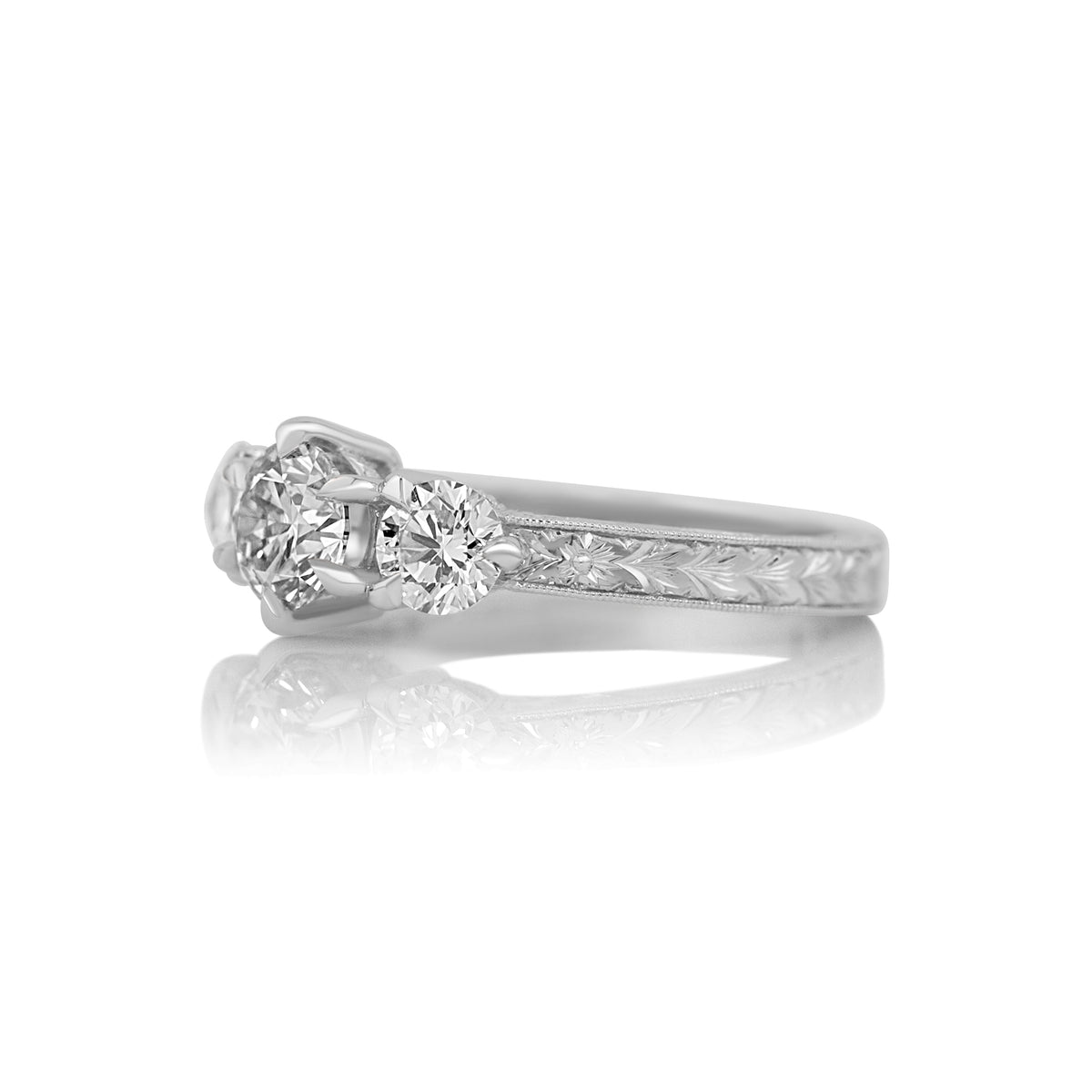 Side profile of the Francesca three stone ring showing the hand engraved band