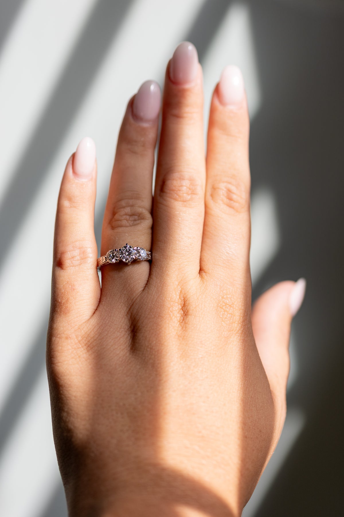 Francesca 1.38ctw three stone engraved ring worn on the hand in 14k white gold