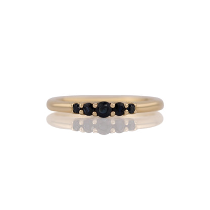 Lab grown sapphire five stone band ring in 14k yellow gold, size 8, shown head on against a white background