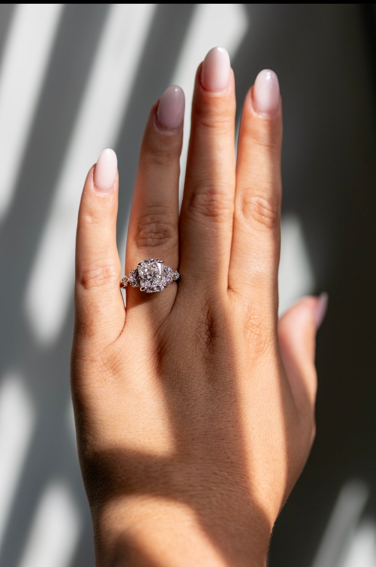 4.05ct cushion cut ring worn on the hand in 14k white gold