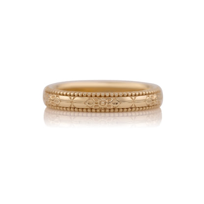 Orange blossom hand engraved wedding band in 14k yellow gold, size 5.25, shown against a white background