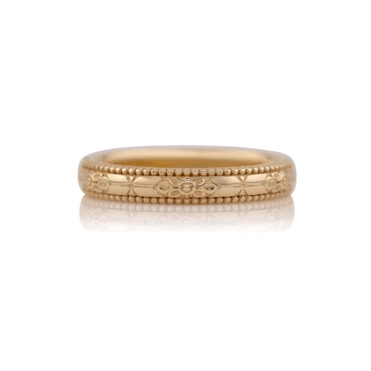 Orange blossom hand engraved wedding band in 14k yellow gold, size 5.25, shown against a white background