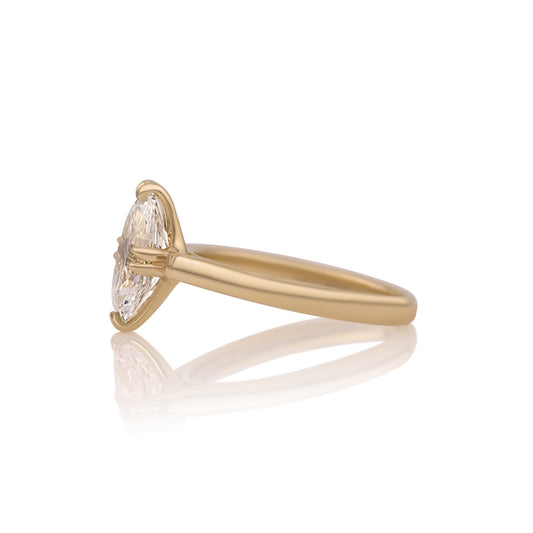 Side profile of the Vera ring showing the double claw prongs holding the moval center stone