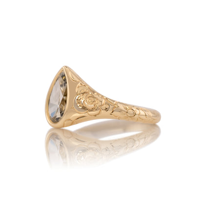 Side profile of the Lenora ring showing the smooth bezel around the champagne pear