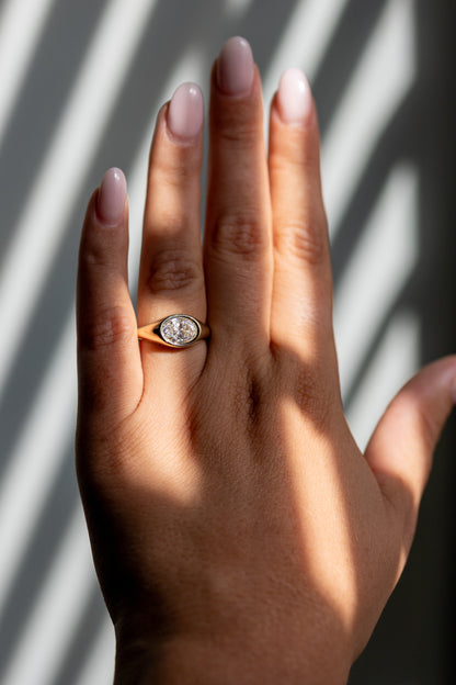 1.59ct oval east west bezel ring worn on the hand in 14k yellow gold
