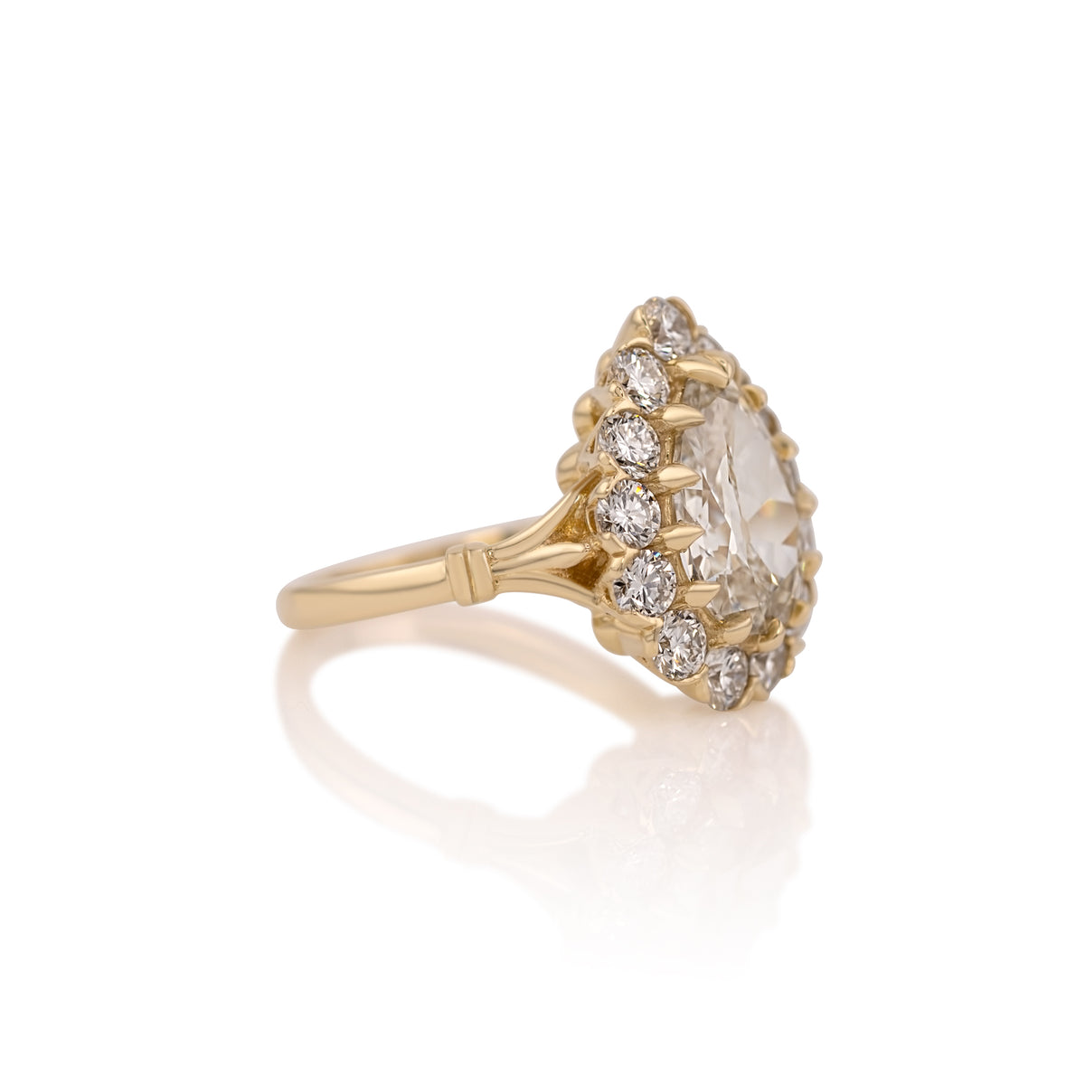 Side profile of the Callie pear halo ring showing the setting and band