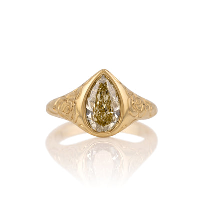 2.09ct champagne pear lab diamond bezel ring in 14k yellow gold, shown head on against a white background