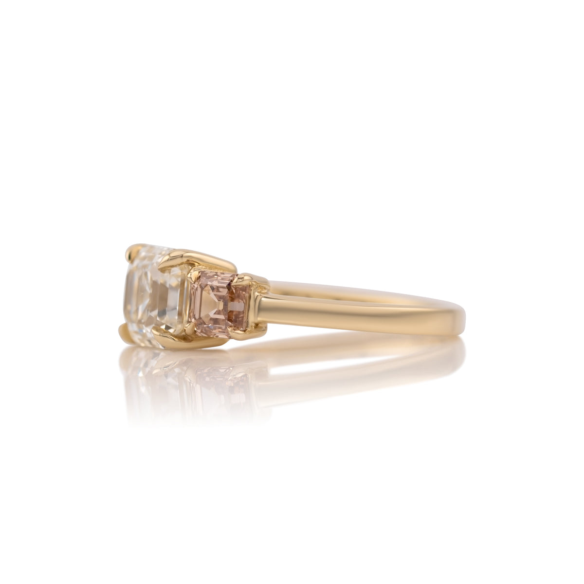 Side profile of the Etta three stone ring showing the champagne Asscher side stones