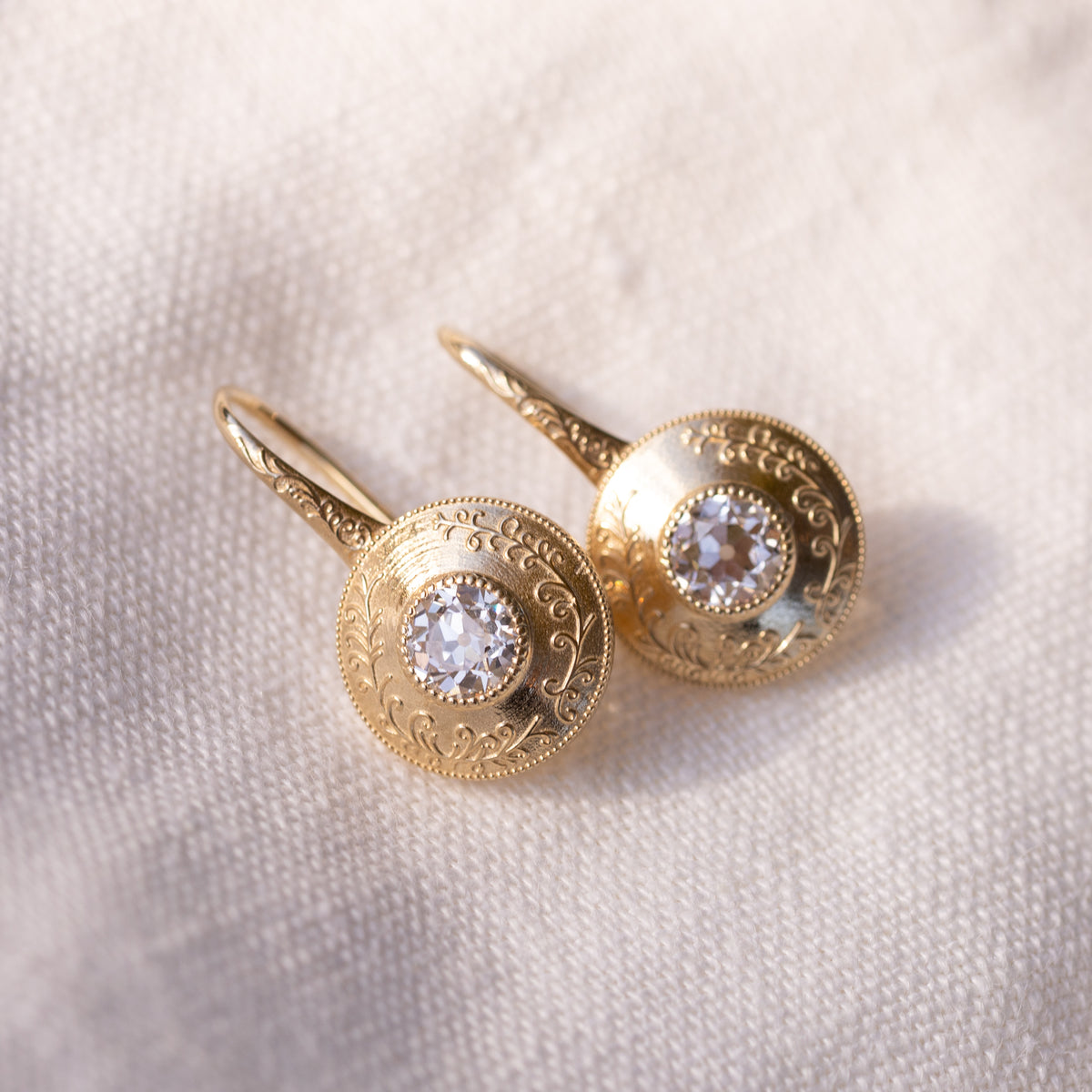 Side view of the Simone drop earrings showing the elongated engraved ear wires