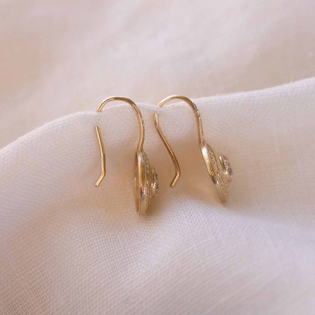 Simone drop earrings worn, an antique inspired medallion design