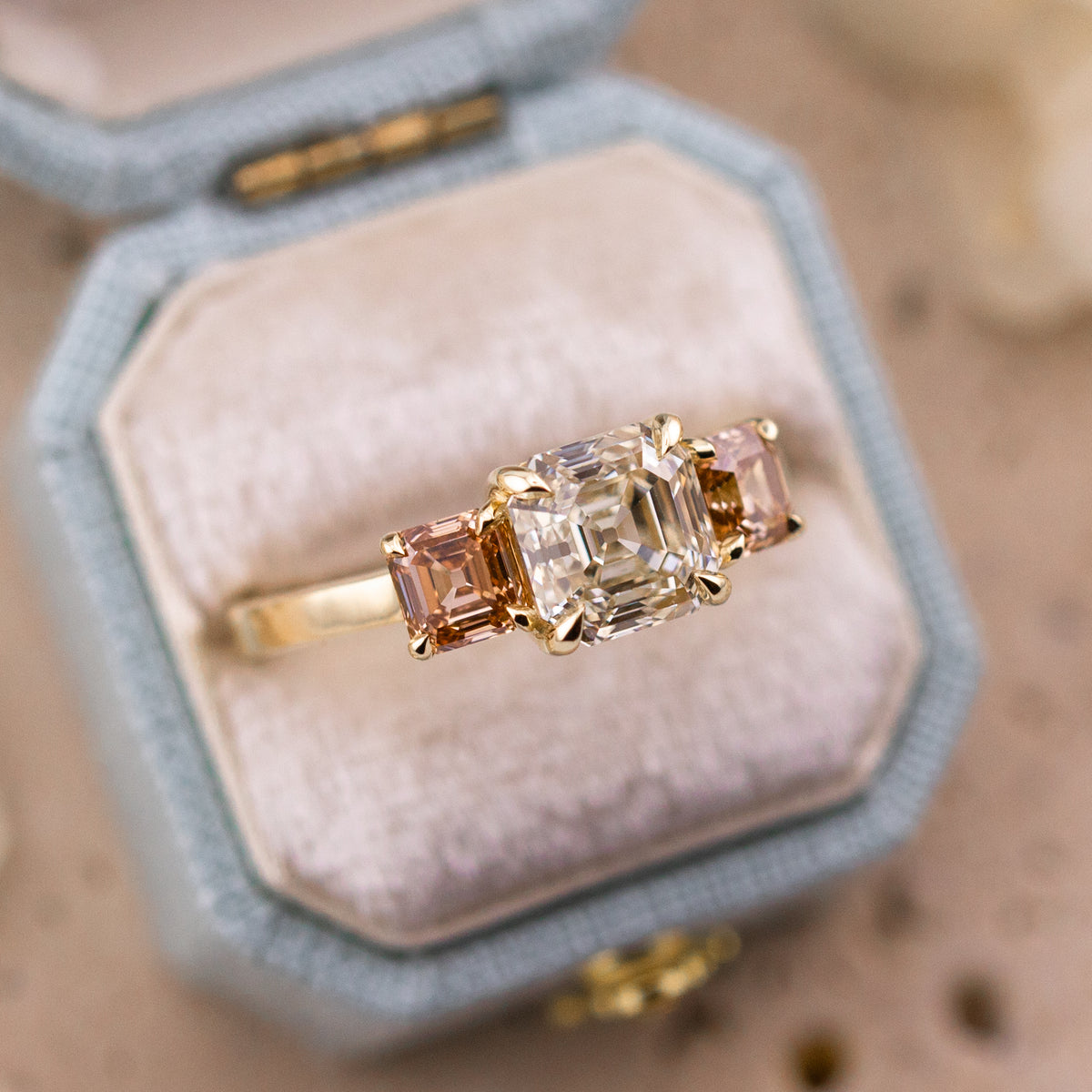 Etta Asscher three stone ring worn on the hand in 14k yellow gold