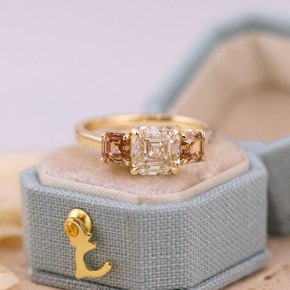 Etta three stone ring, a K color VVS2 Asscher cut diamond between pink brown champagne Asschers