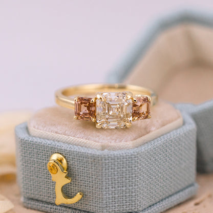 Etta three stone ring, a K color VVS2 Asscher cut diamond between pink brown champagne Asschers