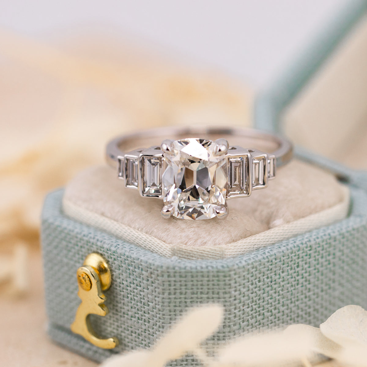 Softly rounded corners and lively faceting of the old mine cut center stone
