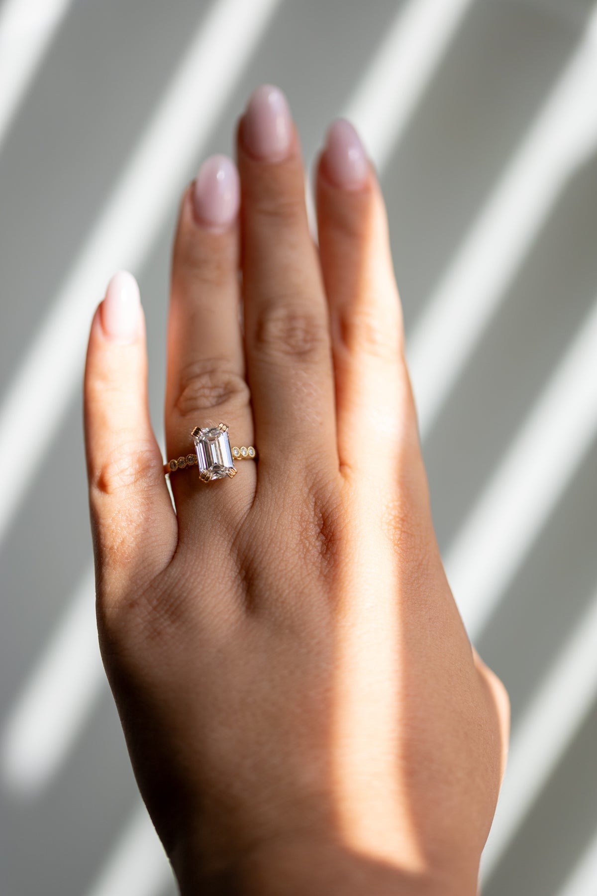 Celeste 3.06ct emerald cut ring worn on the hand in 14k yellow gold