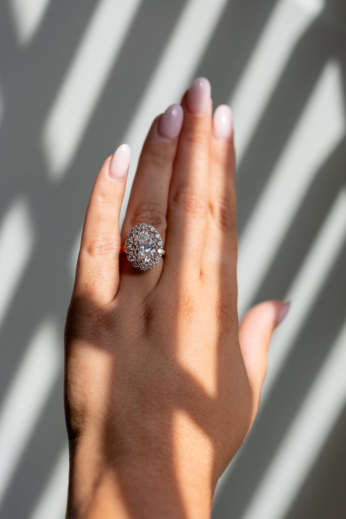 Callie 4.01ct oval halo ring worn on the hand in 14k yellow gold