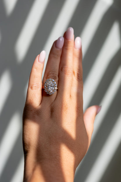 Callie 4.01ct oval halo ring worn on the hand in 14k yellow gold