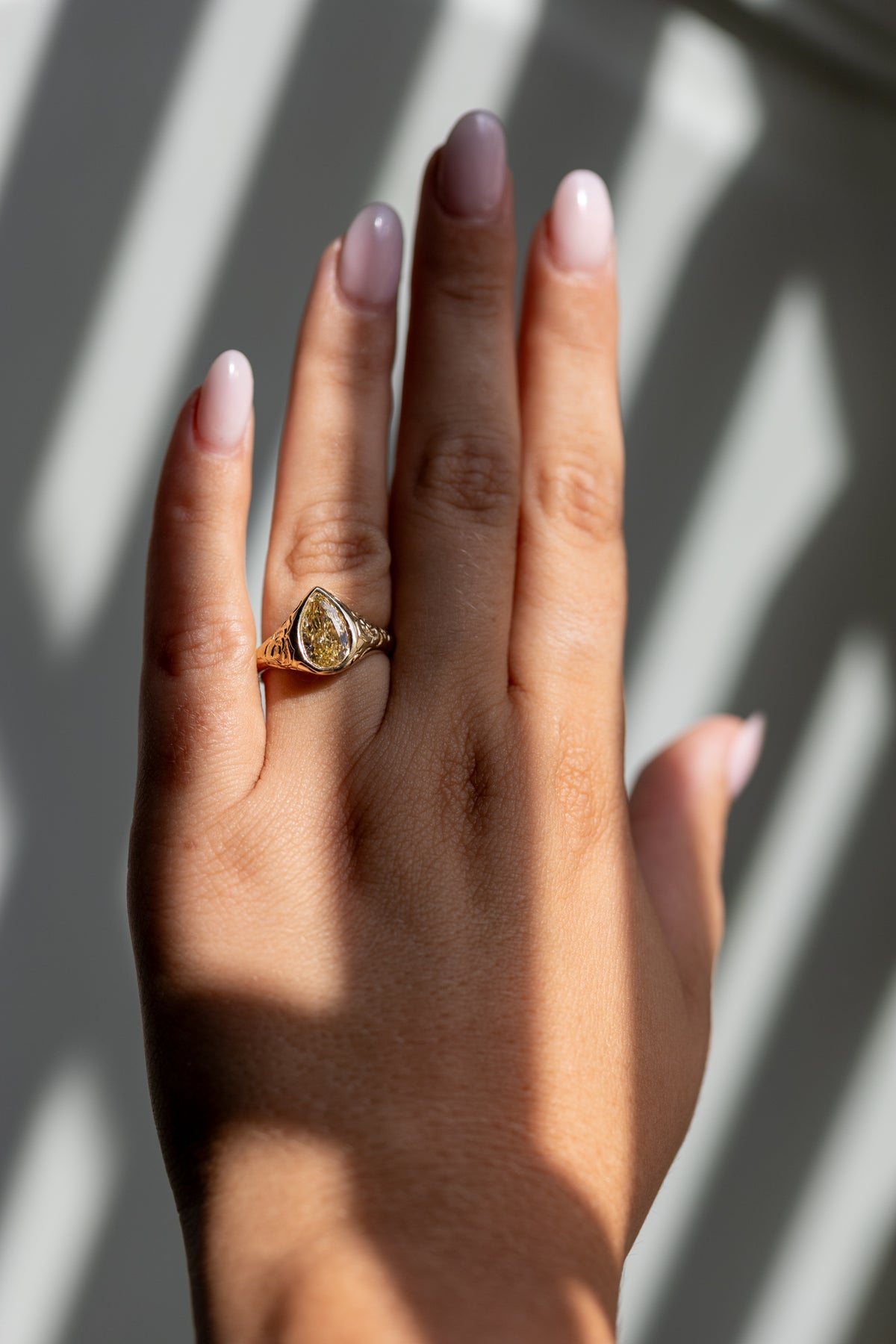 Lenora 2.09ct champagne pear bezel ring worn on the hand in 14k yellow gold