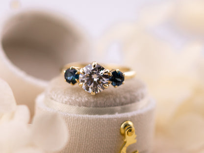 1.70ct Round cut three stone engagement ring with sapphire side stones