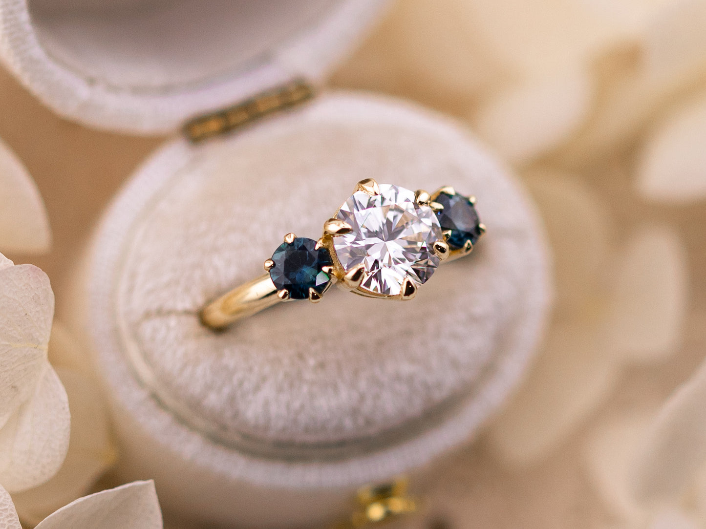 1.70ct Round cut three stone engagement ring with sapphire side stones