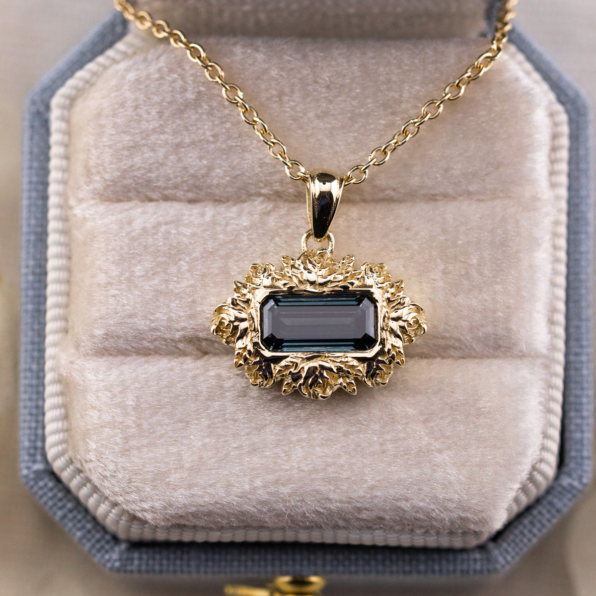 Deep oceanic blue green tones shifting across the emerald cut diamond