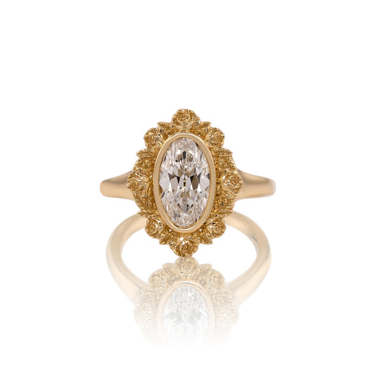 1.51ct moval lab diamond floral halo ring in 14k yellow gold, shown head on against a white background